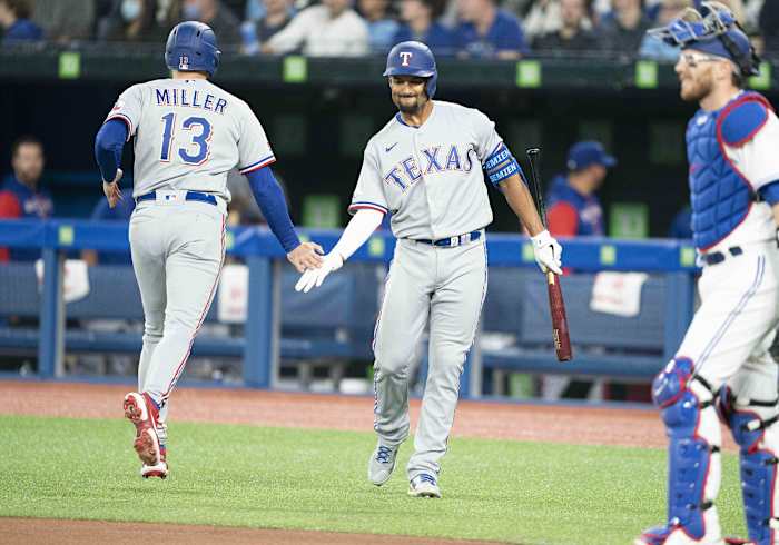Apr 8, 2022; Toronto, Ontario, CAN; Texas Rangers left fielder Brad Miller (13) celebrates hitting a home run with second baseman Marcus Semien (2) during the first inning against the Toronto Blue Jays at Rogers Centre . Mandatory Credit: Nick Turchiaro-USA TODAY Sports